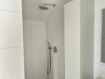 a bathroom with a shower with a glass door at Appartement Huis ter Duinstraat in Noordwijk aan Zee