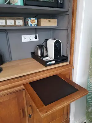 a kitchen counter with a toaster and a microwave at B&B Purmavida in Purmerend