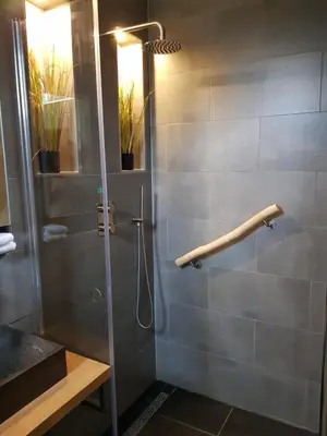 a shower in a bathroom with a glass door at B&B Purmavida in Purmerend
