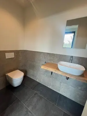 a bathroom with a toilet and a sink at Duinpoort Appartement in Castricum
