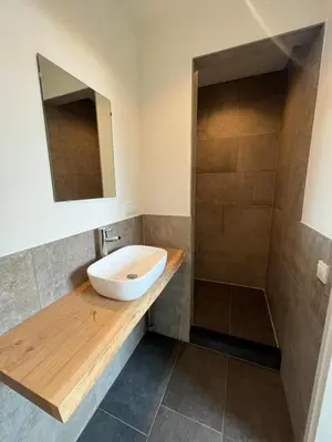 a bathroom with a sink and a shower at Duinpoort Appartement in Castricum