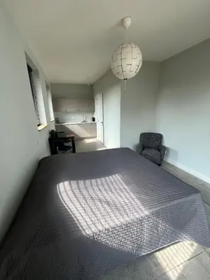 a bedroom with a large bed in a room at Duinpoort Appartement in Castricum