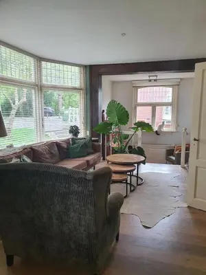 a living room with a couch and a table at Fantastic house with a large roof terrace downtown in Alkmaar