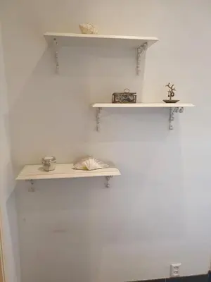 a room with white shelves on a white wall at Fantastic house with a large roof terrace downtown in Alkmaar