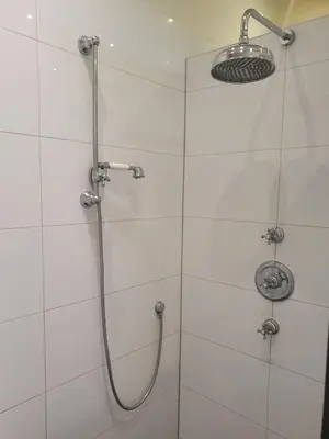a shower with a shower head in a bathroom at Fantastic house with a large roof terrace downtown in Alkmaar
