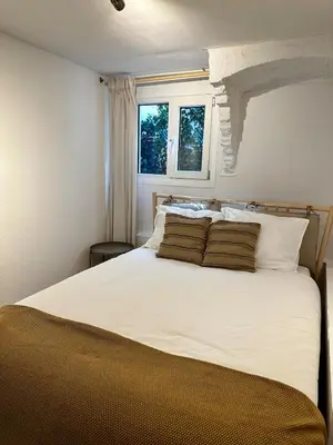 a bedroom with a large white bed with two pillows at Cozy Apartment in Aalsmeer in Aalsmeer