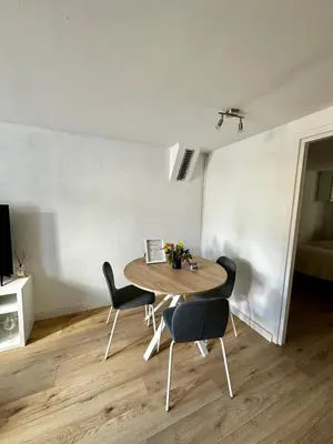 a dining room with a table and chairs in a room at Cozy Apartment in Aalsmeer in Aalsmeer