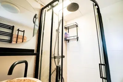 a shower with a glass door in a bathroom at De Polderhoeve in Heerhugowaard