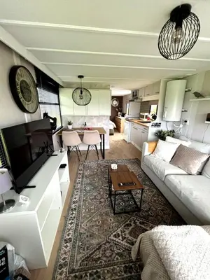 a living room with a couch and a table at De Polderhoeve in Heerhugowaard