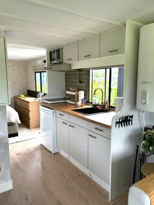 a kitchen with white cabinets and a counter top at De Polderhoeve in Heerhugowaard