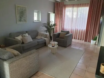 a living room with a couch and a table at Guesthouse 10 in Schellinkhout