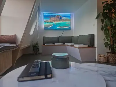 a remote control sitting on a table in a living room at Modern and cozy, top location in Amsterdam