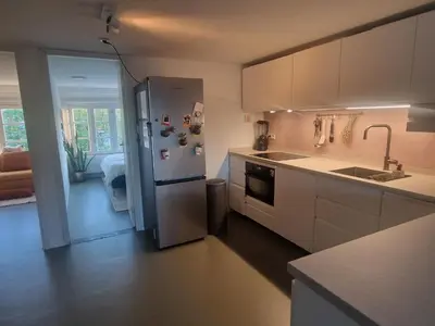 a kitchen with a stainless steel refrigerator in a room at Modern and cozy, top location in Amsterdam