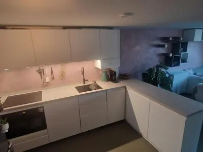 a kitchen with white cabinets and a sink at Modern and cozy, top location in Amsterdam