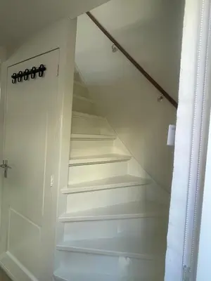 a staircase in a house with white shelves at Wendy's Tiny Beachhouse in Noordwijk
