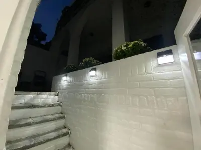 a white brick wall with lights on it at Studio Alexander with private indoor parking in Zandvoort