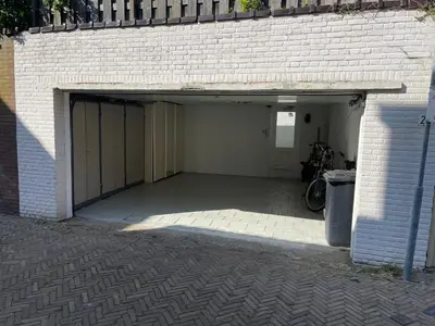 a garage with a bike parked inside of it at Studio Alexander with private indoor parking in Zandvoort
