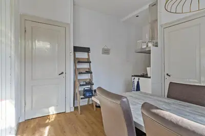a room with a table and chairs and a ladder at Authentic stay in Alkmaar in Alkmaar