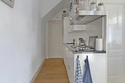 a small white kitchen with a stove top oven at Authentic stay in Alkmaar in Alkmaar