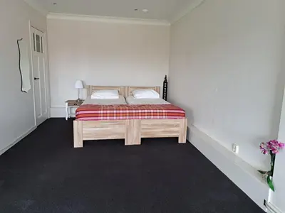 a bedroom with a bed with two pillows on it at Chang in Egmond aan den Hoef