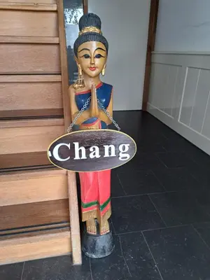 a figurine of a woman holding a sign at Chang in Egmond aan den Hoef