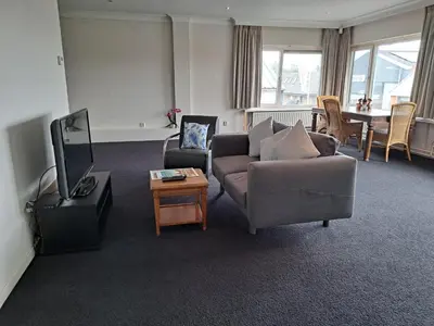 a living room with a couch and a tv at Chang in Egmond aan den Hoef
