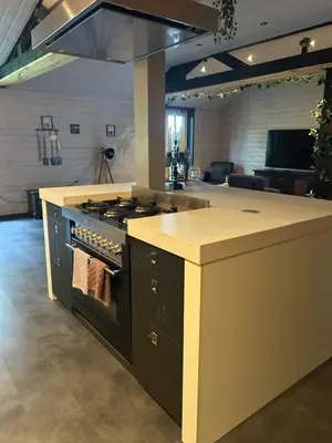 a kitchen with a stove and a counter top at Onder de hanebalken in Dirkshorn
