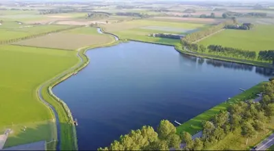 an aerial view of a river in a field at Onder de hanebalken in Dirkshorn