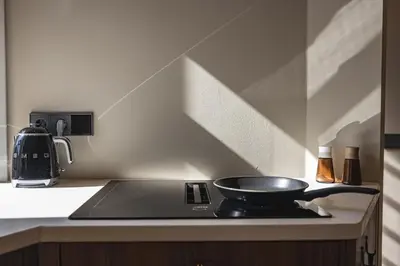 a frying pan sitting on top of a stove in a kitchen at Boutique Studio VO38 in Alkmaar