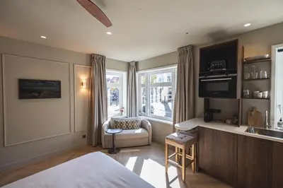 a bedroom with a bed and a kitchen with a sink at Boutique Studio VO38 in Alkmaar