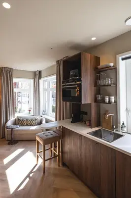 a kitchen with a sink and a couch in a room at Boutique Studio VO38 in Alkmaar