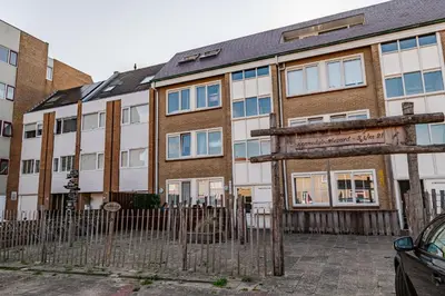 a building with a sign in front of it at B&b aan zee in Egmond aan Zee