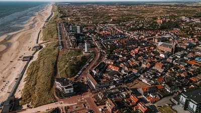 an aerial view of a city and the beach at B&b aan zee in Egmond aan Zee