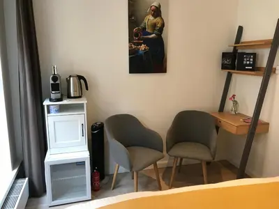 a room with two chairs and a painting on the wall at Rust B&B in Amsterdam