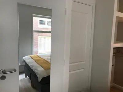 a bedroom with a door leading to a bed at Rust B&B in Amsterdam