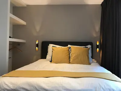 a bedroom with a bed with yellow pillows at Rust B&B in Amsterdam