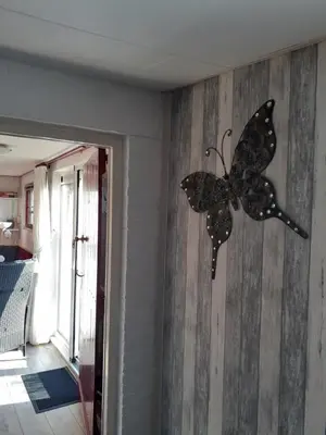 a butterfly decoration on the wall of a room at Dirosa in Onderdijk