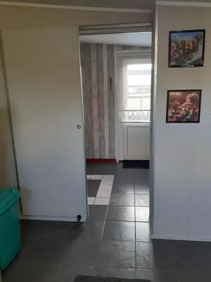 an open door to a room with a tile floor at Dirosa in Onderdijk