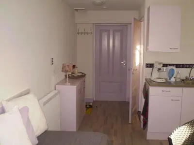 a small kitchen with a sink and a door at Dirosa in Onderdijk