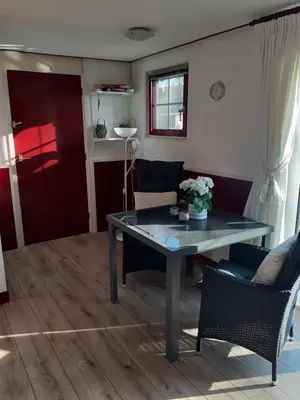 a dining room with a table and two chairs at Dirosa in Onderdijk