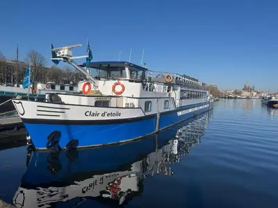 a boat is docked in the water at Botel Clair d'Etoile in Amsterdam
