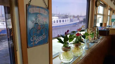 a window with two vases with flowers on a table at Botel Clair d'Etoile in Amsterdam