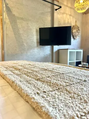 a bedroom with a bed and a flat screen tv at Saltéa Beach House Noordwijk in Noordwijk aan Zee