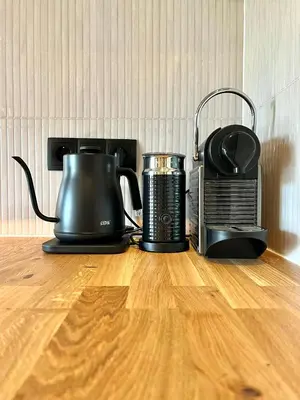 two appliances sitting on top of a wooden table at Saltéa Beach House Noordwijk in Noordwijk aan Zee