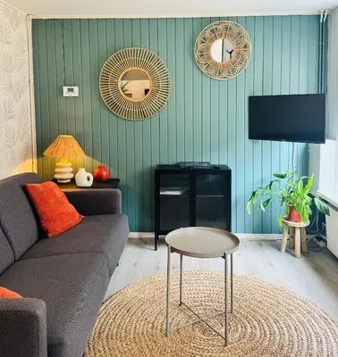 a living room with a couch and a table at Het zandhuisje 84 in Noordwijk aan Zee