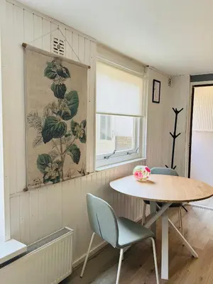 a dining room with a table and two chairs at Het zandhuisje 84 in Noordwijk aan Zee