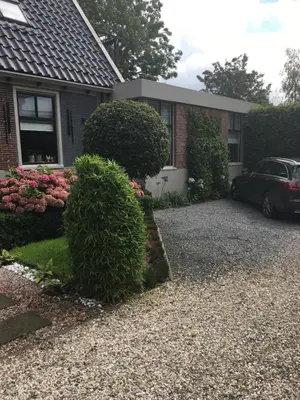 a house with a car parked in the driveway at Agapanthus bed and breakfast in Hoogkarspel