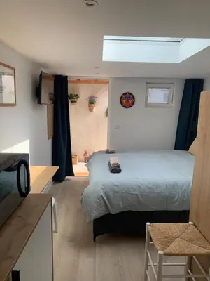 a bedroom with a bed and a television in it at Studio South Beach II with free parking in Zandvoort