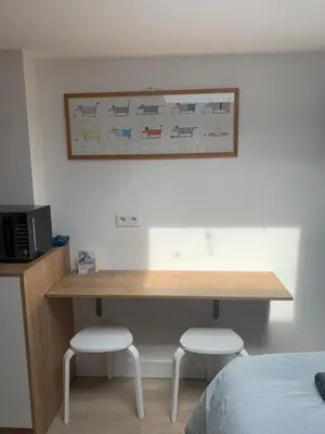 a desk in a bedroom with two stools under it at Studio South Beach II with free parking in Zandvoort
