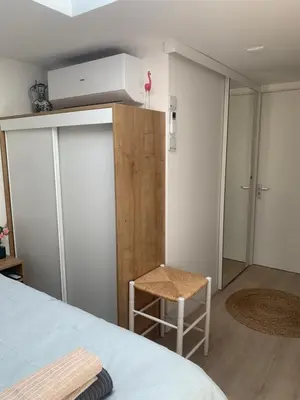 a bedroom with a bed and a desk and a room at Studio South Beach II with free parking in Zandvoort